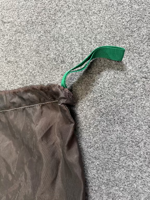 grey drawstring sail bag with green handle